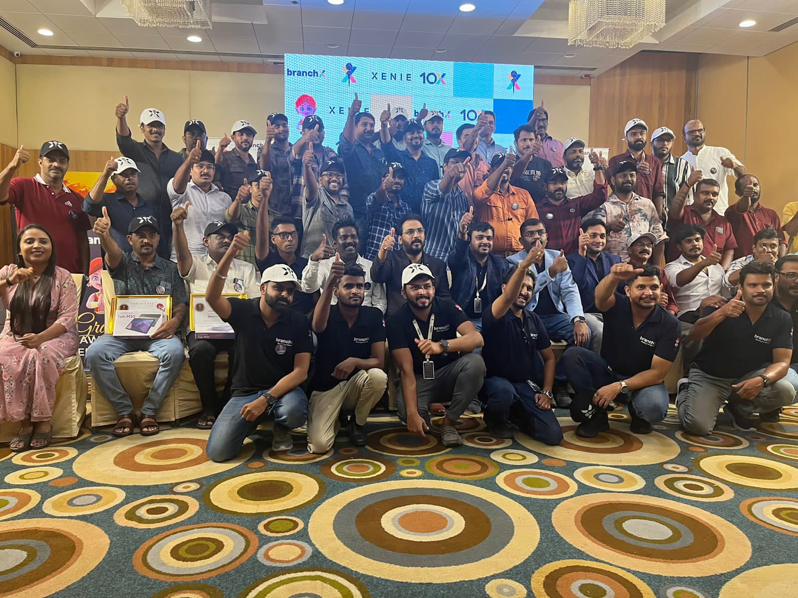Retailers celebrating on stage at a BranchX Xenie partner event