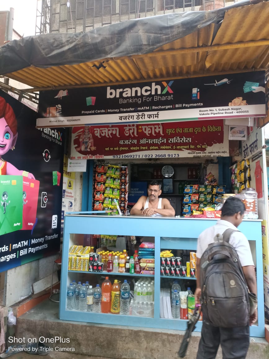 Shopkeeper at the counter of a BranchX-branded kirana store in Mumbai